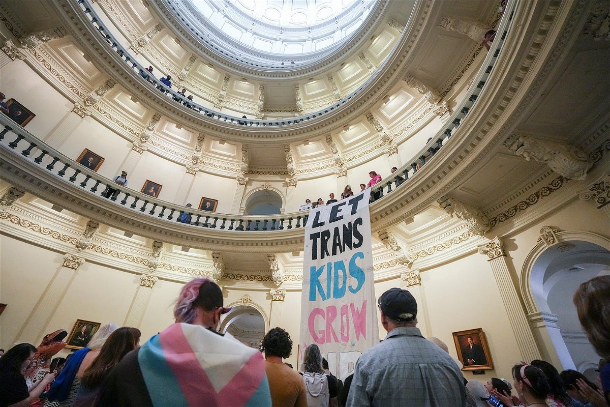 <i>Mikala Compton/American-Statesman/USA Today Network via CNN Newsource</i><br />Equality Texas leadership drops a banner in the Capitol rotunda as LGBTQ rights activists protest SB14 at the Capitol of Texas in May 2023. The state of Texas is suing the Biden administration over recently announced federal protections for LGBTQ+ students.