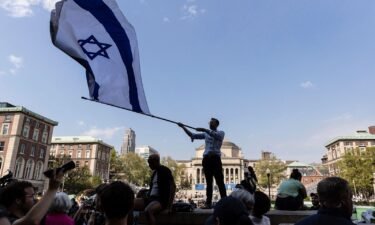 A student waves an Israeli flag outside the protest encampment on the Columbia University campus in New York City on April 29.