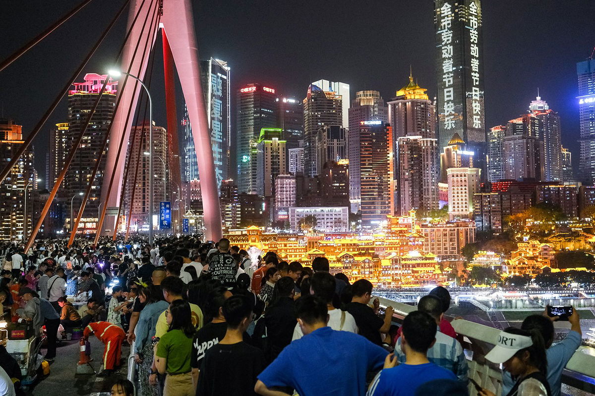 <i>He Penglei/China News Service/VCG/Getty Images via CNN Newsource</i><br/>Tourists visit the Qiansimen Jialing River Bridge during the May Day holiday on May 1