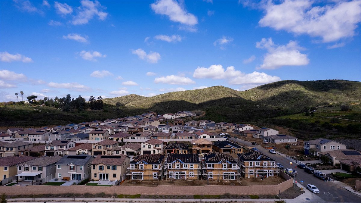 <i>Mike Blake/Reuters via CNN Newsource</i><br/>A drone view shows single-family homes at a new subdivision under construction in the rural hills of San Marcos