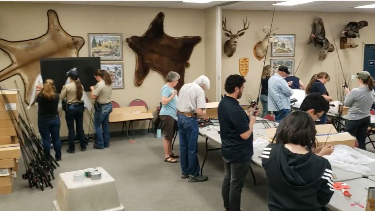 CPW staff and volunteers assembling fishing poles for Get Outdoors Day