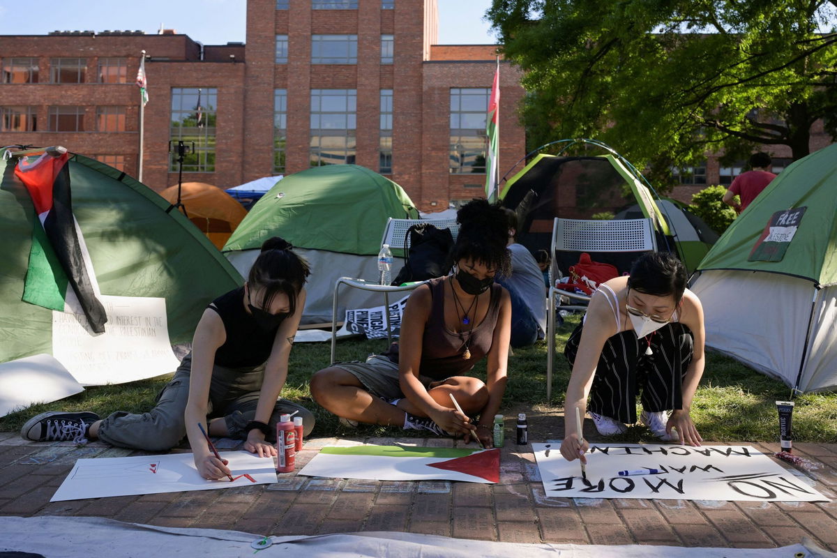 <i>Craig Hudson/Reuters via CNN Newsource</i><br/>Activists make protest signs inside a pro-Palestinian encampment at George Washington University in Washington