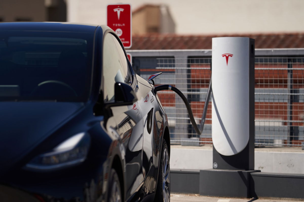 A Tesla charging station in a parking lot in Santa Monica, California, is pictured here in September 2022. Tesla has abruptly fired the team running its electric vehicle charging business.