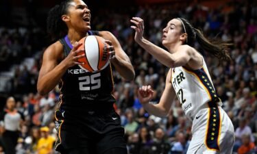 Indiana Fever guard Caitlin Clark scores her first WNBA regular season basket against during a game against the Connecticut Sun in Uncasville