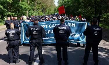 Police confront environmental activists in a forest near Tesla's factory in Germany on Friday.