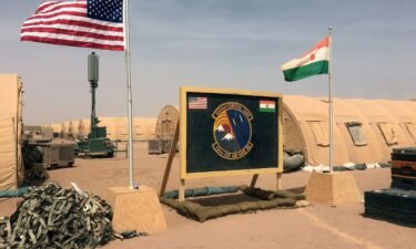 A US and Niger flag are raised side by side at the base camp for air forces and other personnel supporting the construction of Niger Air Base 201 in Agadez