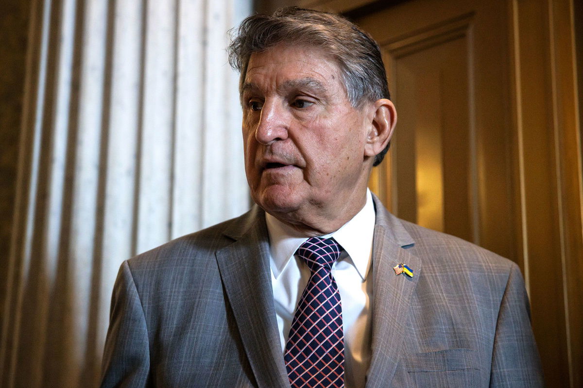 <i>Samuel Corum/Getty Images via CNN Newsource</i><br/>Sen. Joe Manchin talks to reporters as he leaves the Senate floor following a vote on January 23 in Washington