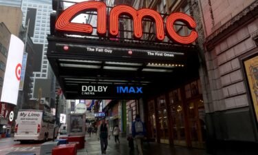 People walk past an AMC movie theater on 42nd Street in Times Square on May 16