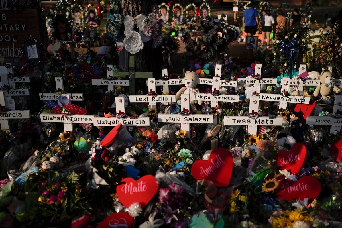 <i>Jae C. Hong/AP via CNN Newsource</i><br />Flowers are piled around crosses with the names of the victims killed in a school shooting as people visit a memorial at Robb Elementary School to pay their respects May 31