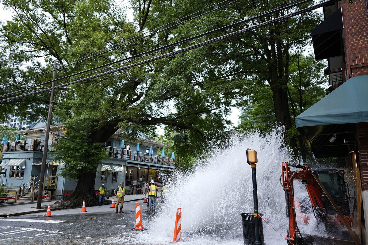 <i>Mike Stewart/AP via CNN Newsource</i><br/>Workers respond to a broken water transmission line Saturday in Atlanta