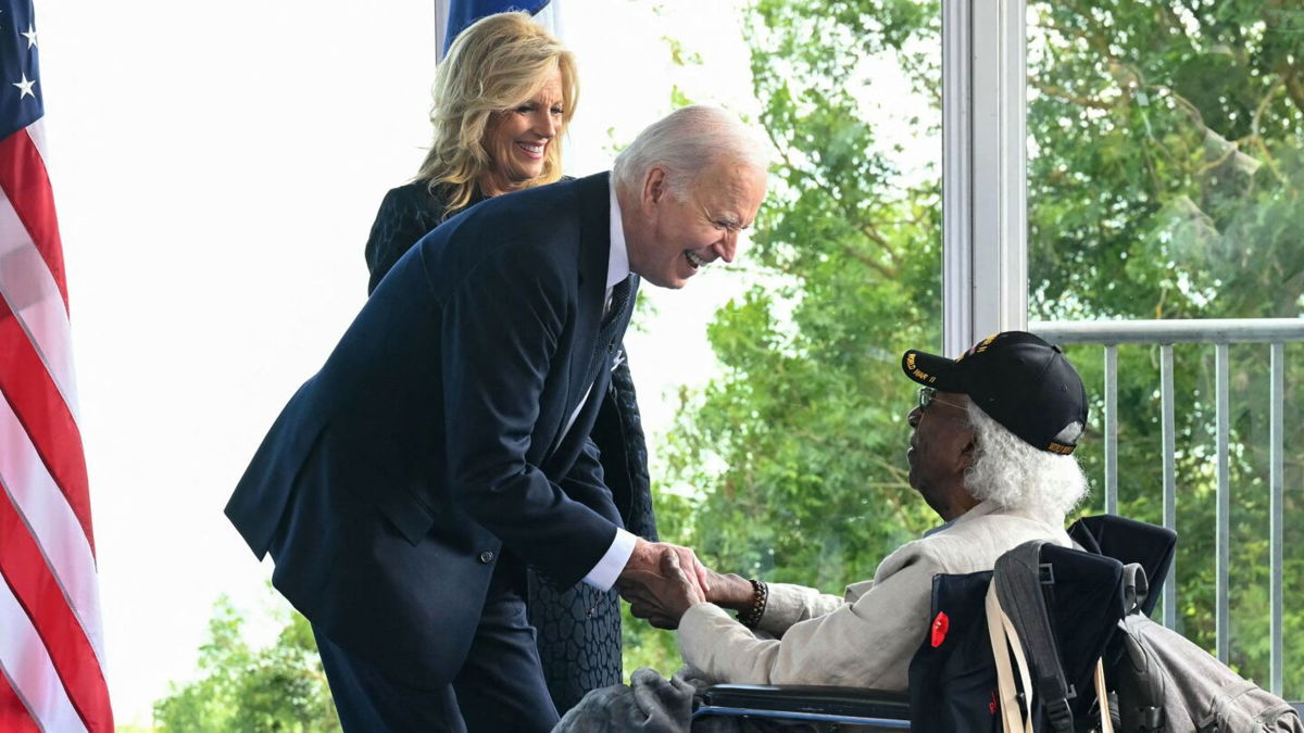 <i>Saul Loeb/AFP/Getty Images via CNN Newsource</i><br/>President Joe Biden and first lady Jill Biden speak with a World War II veteran during the ceremony marking the 80th anniversary of D-Day in Normandy