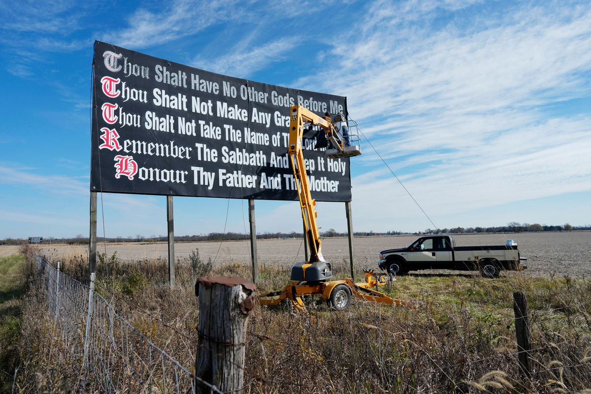 <i>Carolyn Kaster/AP via CNN Newsource</i><br/>A group of Louisiana parents and civil rights organizations are suing the state over its new law that requires all public classrooms to display the Ten Commandments. Workers seen repainting a Ten Commandments billboard off of Interstate 71 on Election Day near Chenoweth