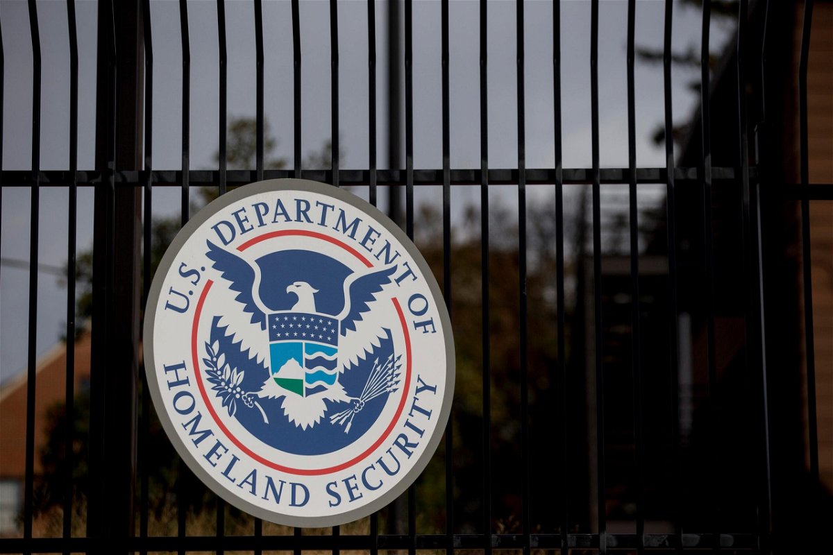 <i>Andrew Harrer/Bloomberg/Getty Images via CNN Newsource</i><br />The US Department of Homeland Security seal hangs on a fence at the agency's headquarters in Washington