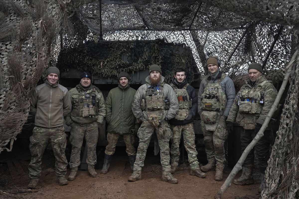 <i>Efrem Lukatsky/AP via CNN Newsource</i><br />Soldiers of the 12th Special Forces Brigade Azov stand in front of a 155mm self-propelled gun on the frontline near Kreminna