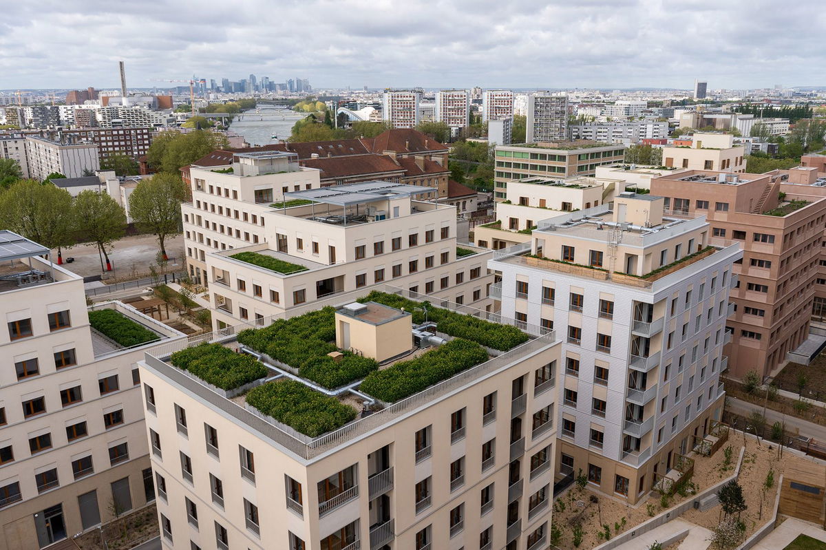 <i>Nathan Laine/Bloomberg/Getty Images via CNN Newsource</i><br/>Solar panels and green roofs top some of the buildings where athletes will stay during the Games.