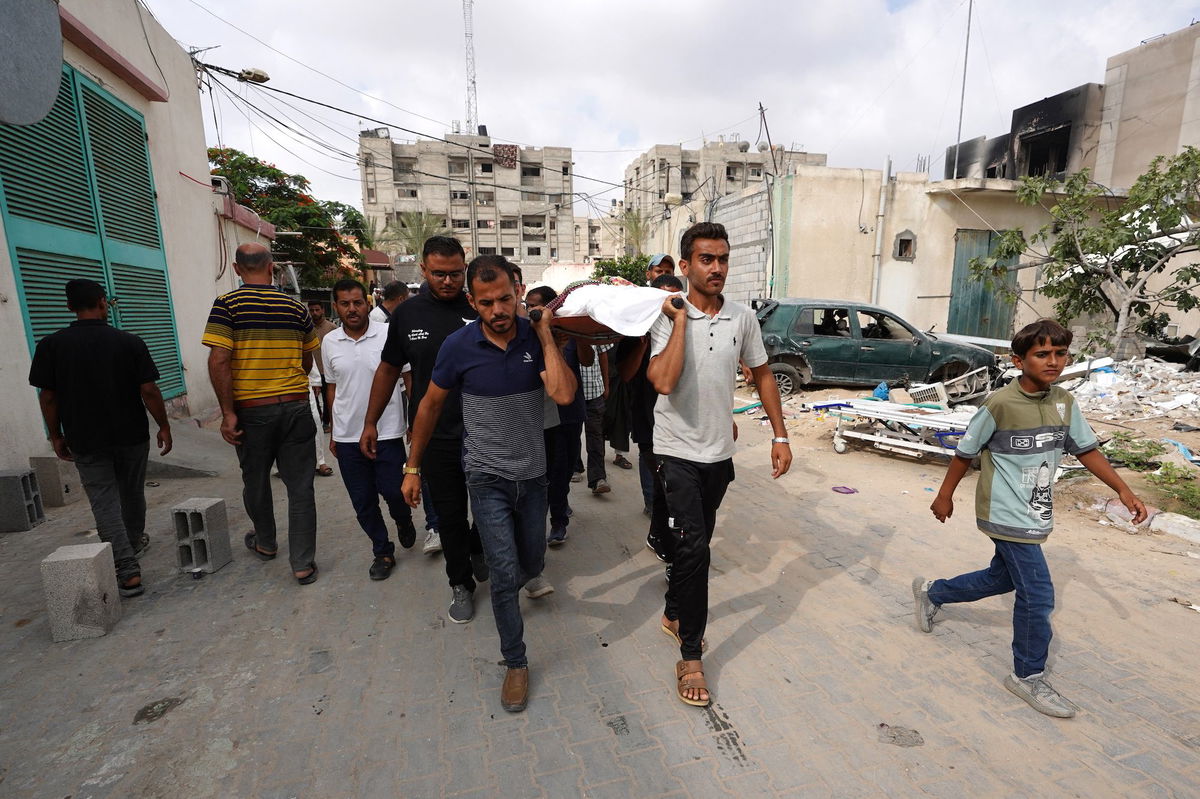 <i>Bashar Taleb/AFP/Getty Images via CNN Newsource</i><br/>A Palestinian man points to ashes in a tented area the day after a strike on Mawasi.