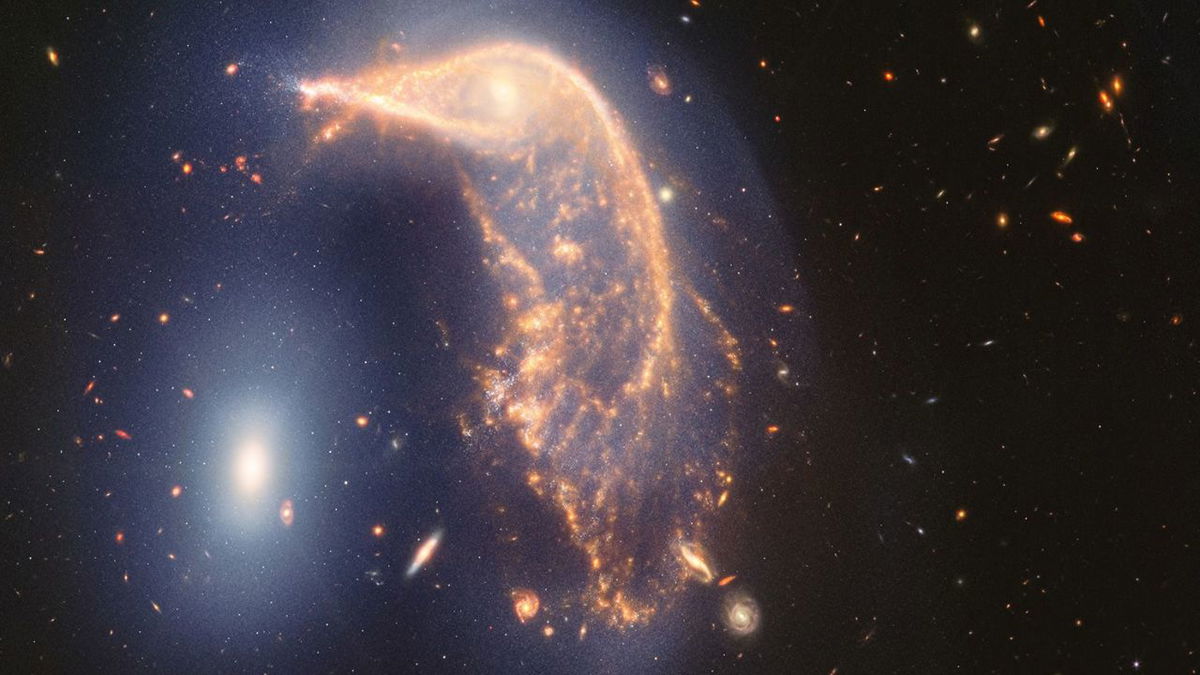 The distorted spiral galaxy at center, the Penguin, and the compact elliptical galaxy at left, the Egg, are locked in an active embrace.
