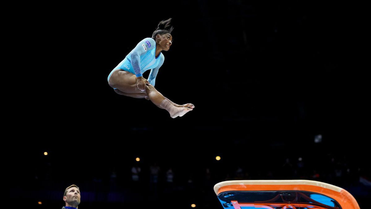 Simone Biles of Team United States performs her new jump routine 'Biles II' with coach Laurent Landi during Women's Qualifications on October 1, 2023 in Antwerp, Belgium.
