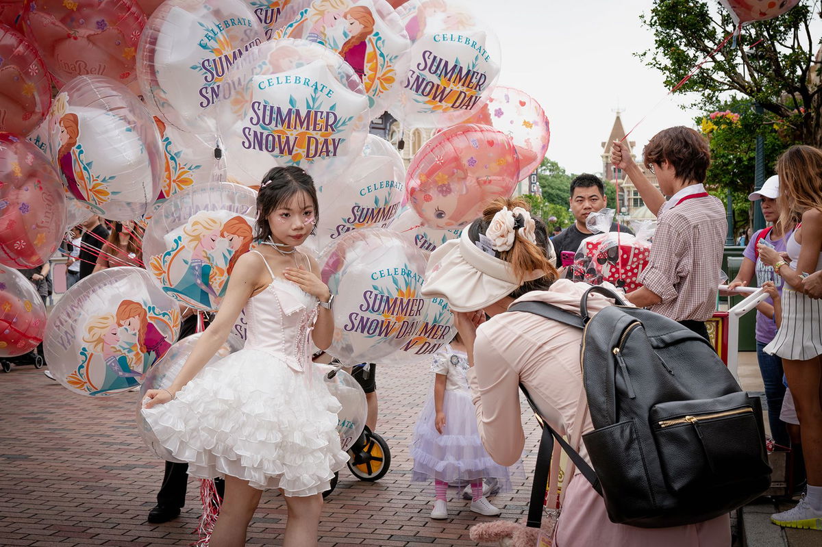 <i>Noemi Cassanelli/CNN via CNN Newsource</i><br/>Many visitors at the park post photos to social media wearing Disney paraphenelia. Some find it a welcome reprieve from the pressures of life outside.