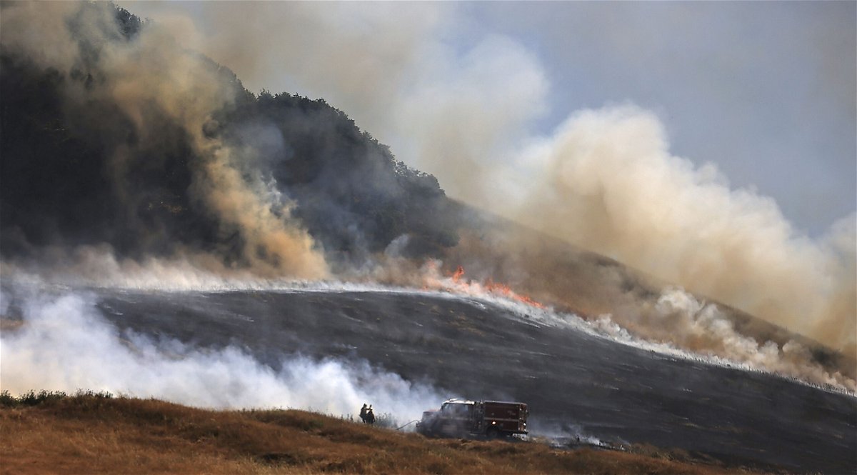 <i>Kent Porter/AP via CNN Newsource</i><br />A wildfire spreads uphill west of Petaluma