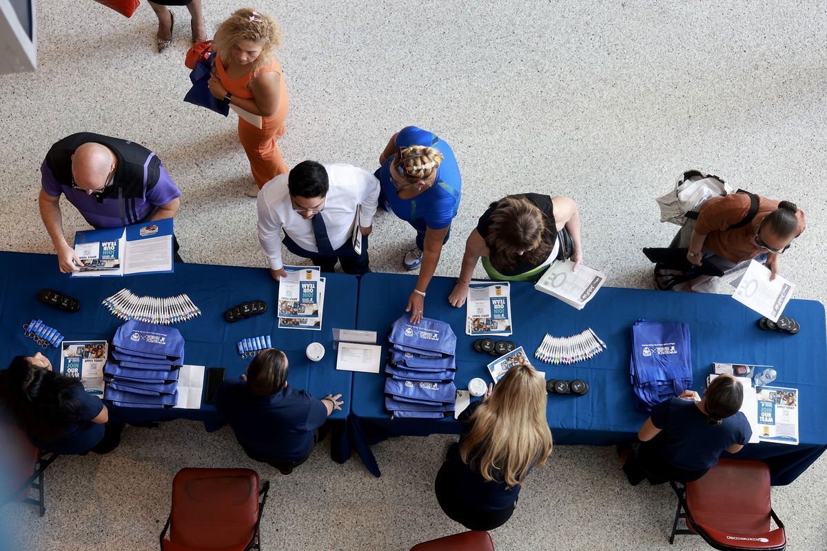 <i>Joe Raedle/Getty Images via CNN Newsource</i><br/>Job seekers attend a job fair on June 26 in Sunrise