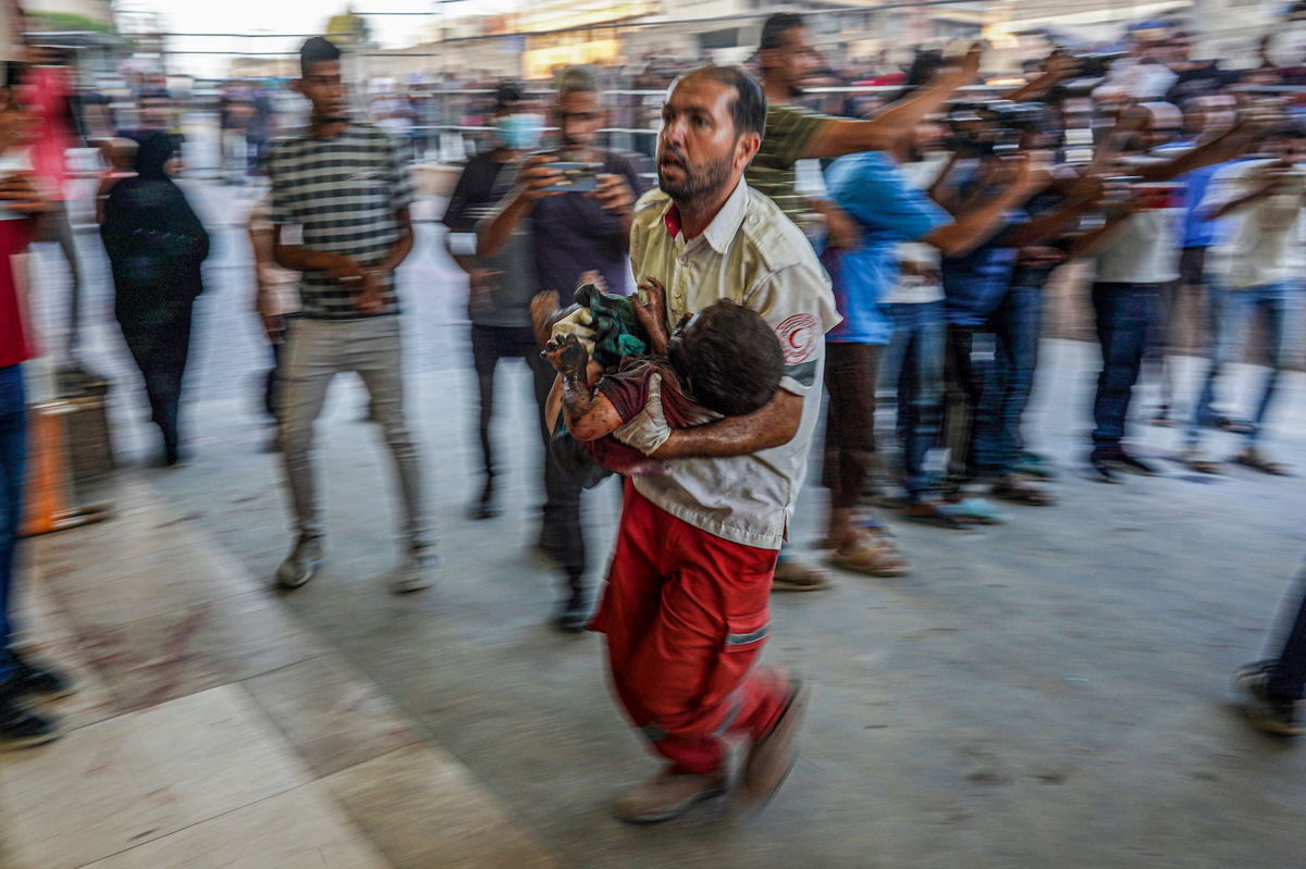 <i>Haitham Imad/EPA-EFE/Shutterstock via CNN Newsource</i><br/>Relatives of killed Palestinians cry next to their bodies inside the morgue at Nasser Hospital in Khan Younis on July 9