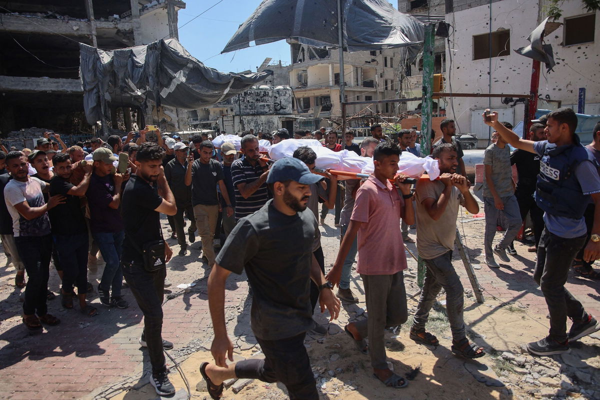 <i>Omar Al-Qattaa/AFP/Getty Images via CNN Newsource</i><br/>Palestinians gather at the site of an Israeli strike which hit a makeshift prayer hall at Al Shati refugee camp west of Gaza City on July 13