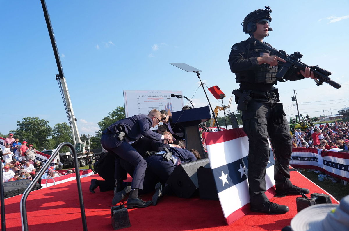 <i>Jabin Botsford/The Washington Post/Getty Images via CNN Newsource</i><br/>Secret service agents cover former president Donald Trump during a campaign rally in Butler