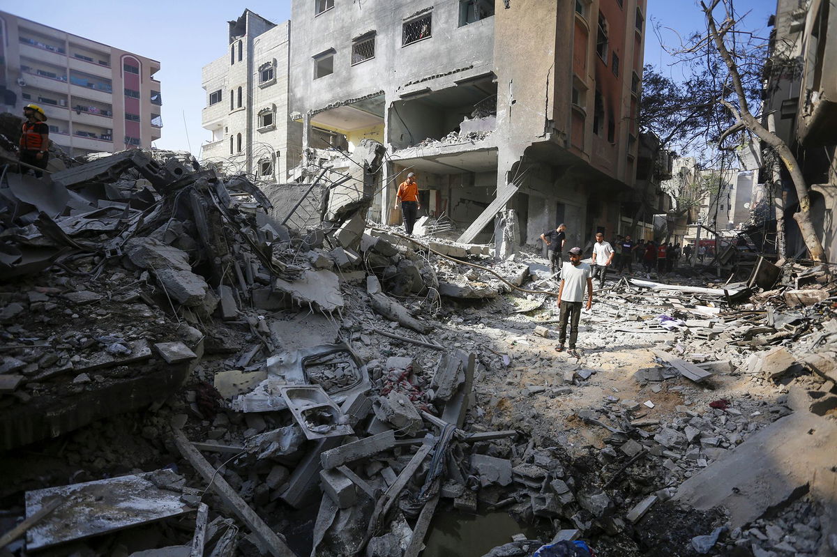 <i>Ashraf Amra/Anadolu/Getty Images via CNN Newsource</i><br/>Civil defense teams and locals investigate the rubble after the Israeli operation in Nuseirat camp