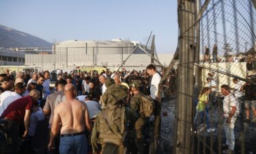 Israeli security forces and medics transport casualties along with local residents