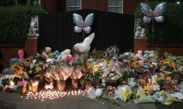 Tributes and candles to the victims of the Southport knife attack laid near the scene on July 30