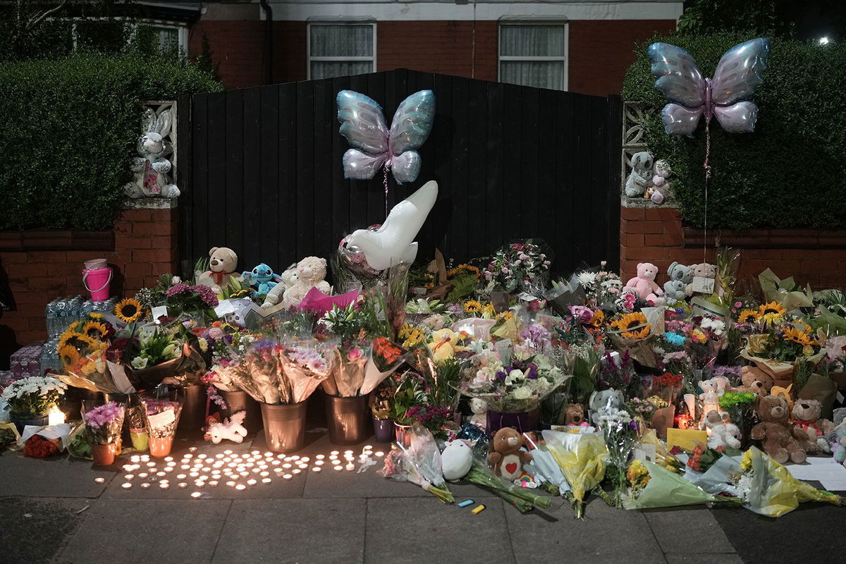 <i>Christopher Furlong/Getty Images via CNN Newsource</i><br/>Tributes and candles to the victims of the Southport knife attack laid near the scene on July 30