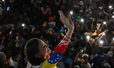 Venezuelan opposition leader Maria Corina Machado waves during the campaign closing rally of presidential candidate Edmundo Gonzalez Urrutia in Caracas on July 25