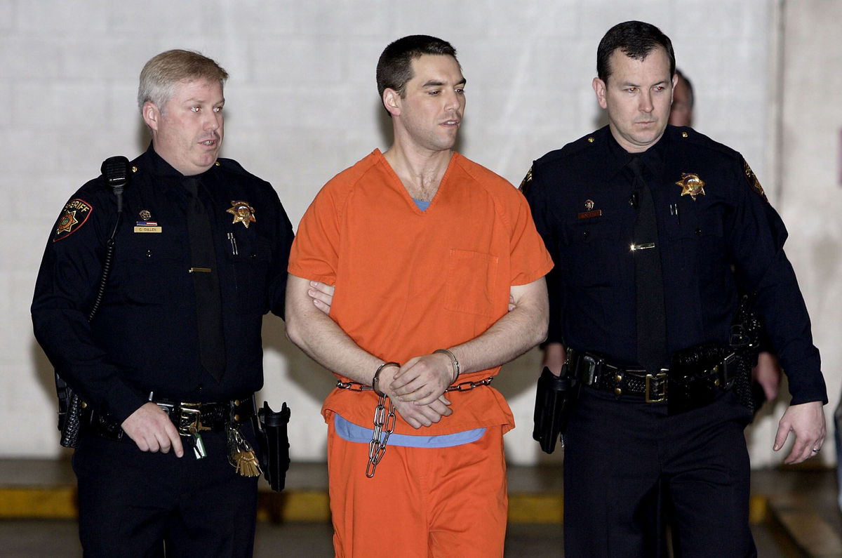 <i>Justin Sullivan/Getty Images via CNN Newsource</i><br/>Convicted murderer Scott Peterson is escorted by two San Mateo County deputies as he is walked from the jail to an awaiting van March 17