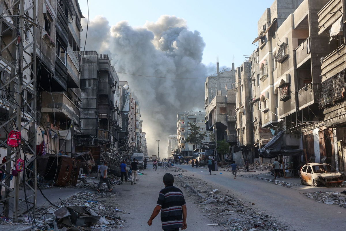 <i>Omar Al-Qattaa/AFP/Getty Images via CNN Newsource</i><br/>Palestinians evacuate a body pulled from the rubble following Israeli bombardment which hit a school complex