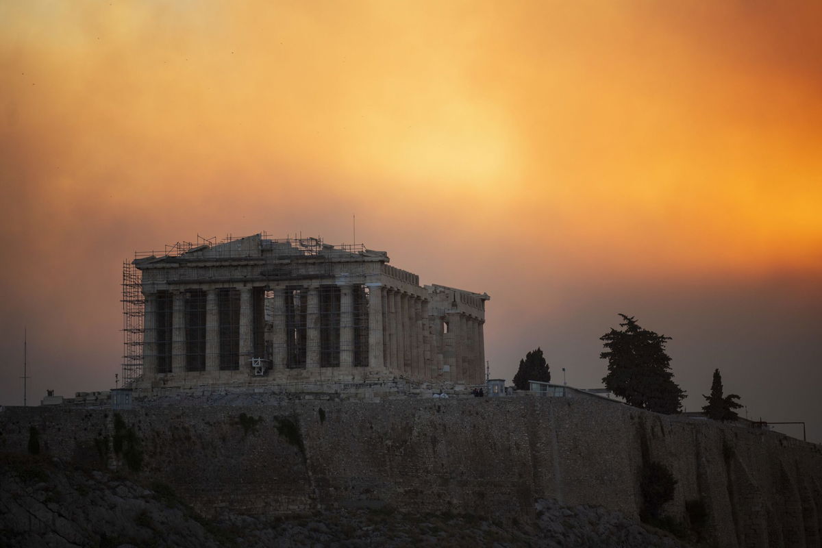 <i>Angelos Tzortzinis/AFP/Getty Images via CNN Newsource</i><br/>Emergency service personnel work to rescue people during wildfires in Varnavas