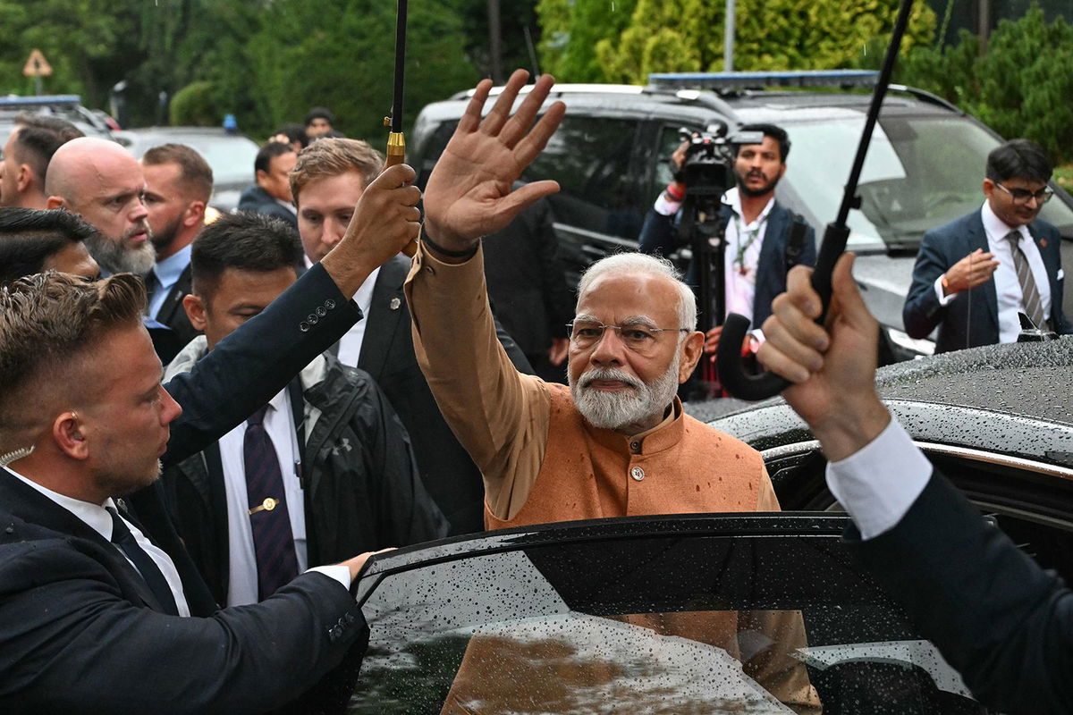 <i>Sergei Gapon/AFP/Getty Images via CNN Newsource</i><br/>Indian Prime Minister Narendra Modi waves as he leaves a memorial in Warsaw