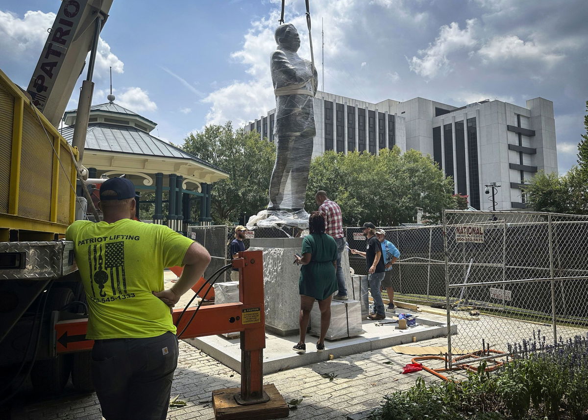 <i>Ron Harris/AP via CNN Newsource</i><br/>A large bronze statue of the late civil rights leader and Congressman John Lewis looks over the town square in Decatur