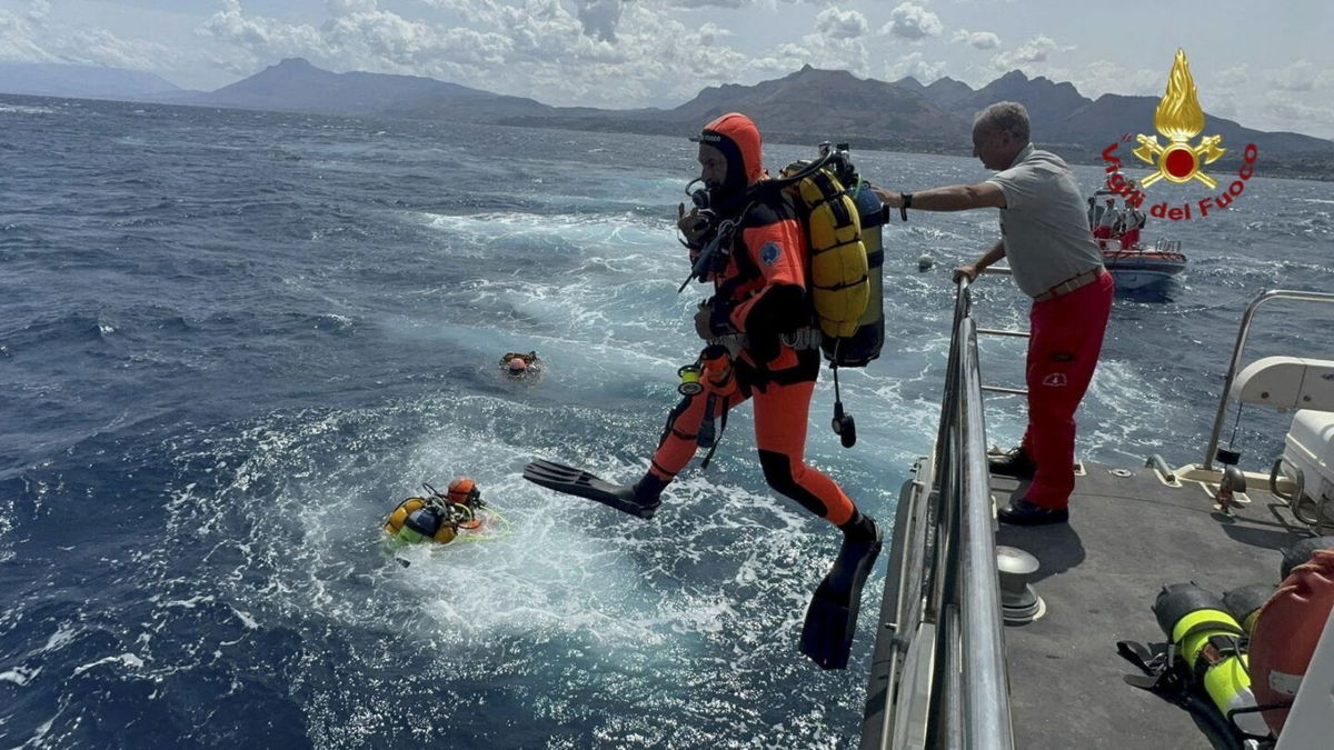 <i>Handout/Vigili del Fuoco/Reuters via CNN Newsource</i><br/>Divers jump into the sea to search for six people missing in Sicily