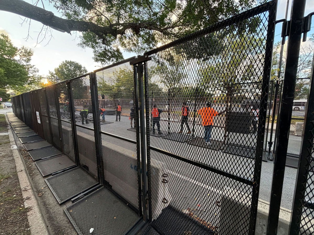 <i>Bill Kirkos/CNN via CNN Newsource</i><br/>Chicago workers set up the additional line of security fences outside the United Center on August 20.