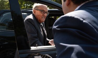 Former New York City Mayor Rudy Giuliani climbs into his vehicle after speaking with people and police outside a designated protest area near the United Center which is hosting the Democratic National Convention on August 20 in Chicago.