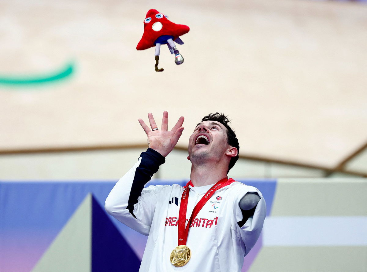 <i>Gonzalo Fuentes/Reuters via CNN Newsource</i><br/>Jaco van Gass celebrates on the podium after taking the gold medal in the men's C3 3000m individual pursuit final.