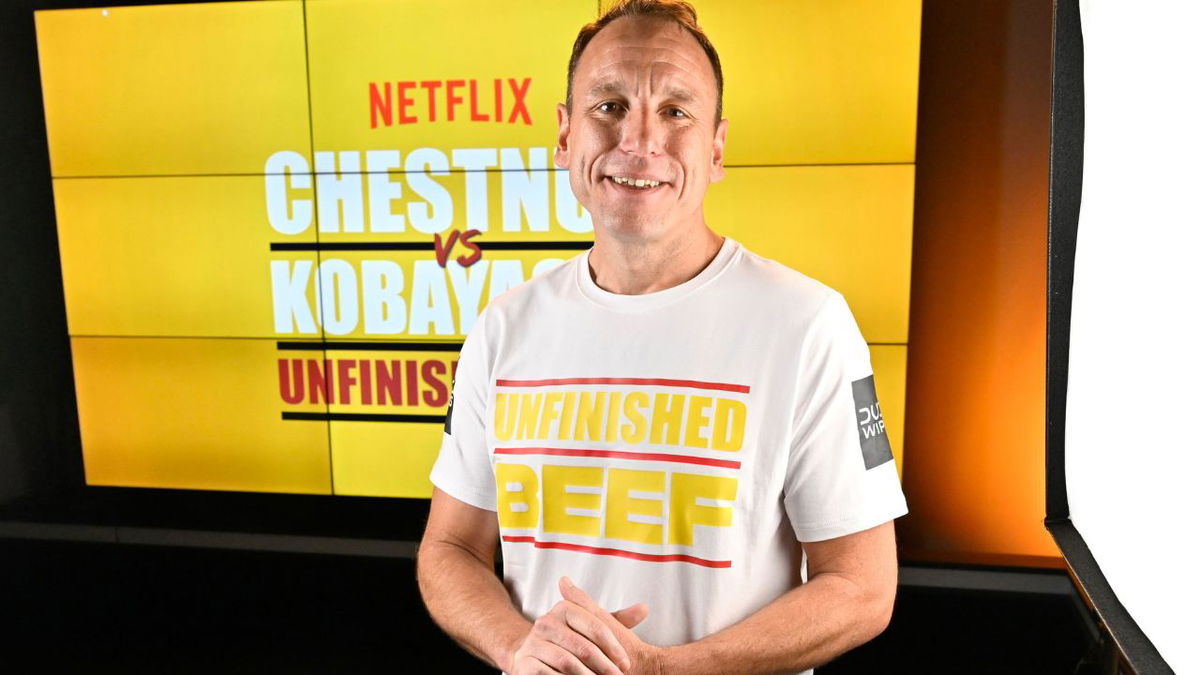 Joey Chestnut breaks own world record by eating 83 hot dogs and buns in Netflix contest on September 2.
