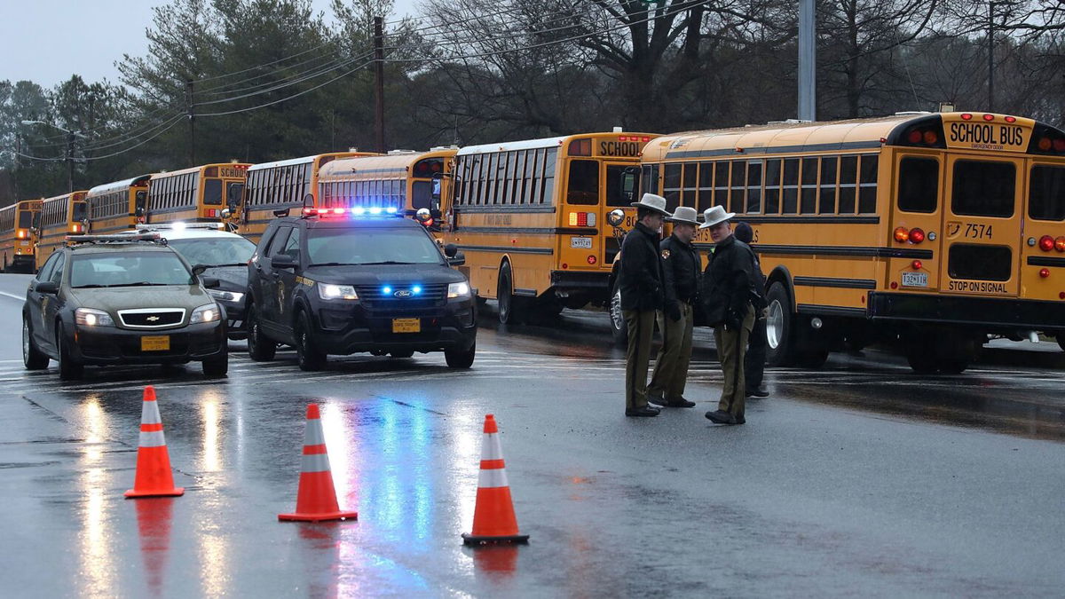 <i>Mark Wilson/Getty Images via CNN Newsource</i><br/>School buses are lined up in front of Great Mills High School after a shooting on March 20