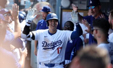 Los Angeles Dodgers' Shohei Ohtani hits a solo home run as Cleveland Guardians starting pitcher Tanner Bibee watches along.