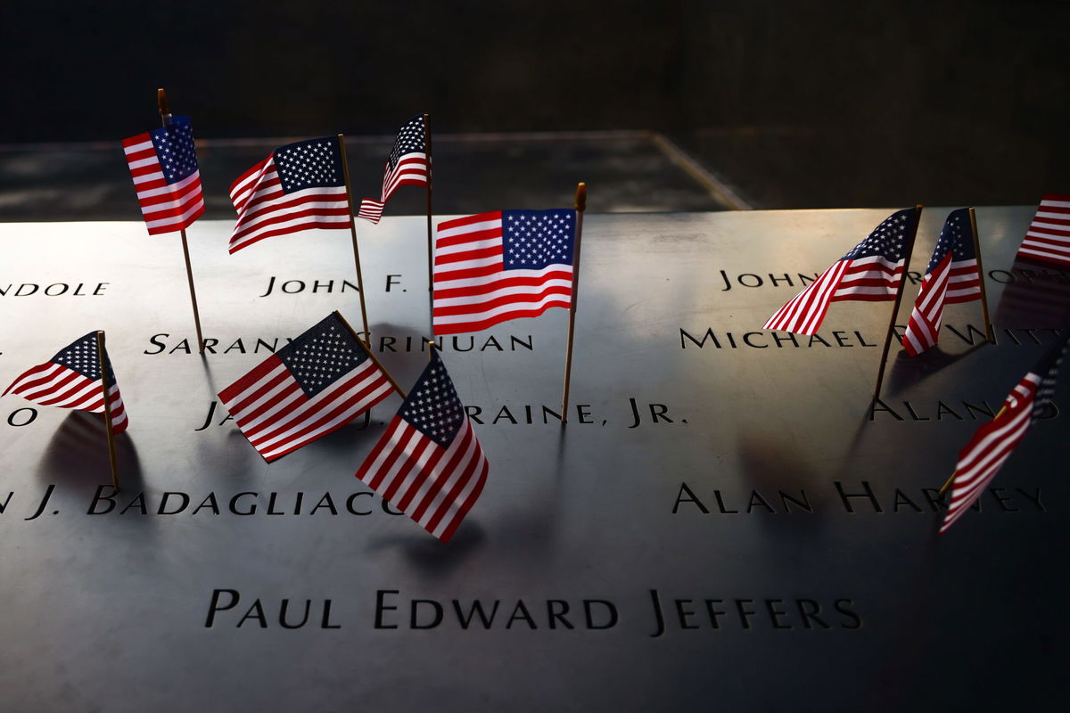 <i>Beata Zawrzel/NurPhoto/Getty Images via CNN Newsource</i><br/>US flags are placed on the names of victims at the South Tower Memorial Pool at the National 9/11 Memorial on Independence Day In New York on July Fourth.