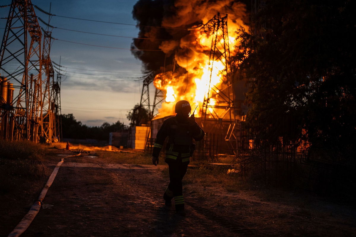 <i>Alex Babenko/AP via CNN Newsource</i><br />A Ukrainian firefighter talks on the radio while he works to extinguish the fire on the site of an electrical substation that was hit by Russian strike in Dnipropetrovsk region