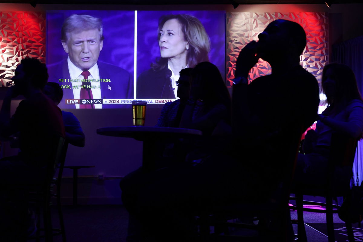 <i>Alex Wong/Getty Images via CNN Newsource</i><br/>People watch the ABC presidential debate during a watch party at Penn Social on September 10