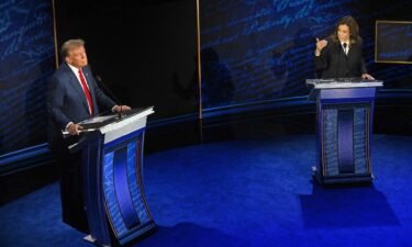 Vice President and Democratic presidential candidate Kamala Harris speaks as former President and Republican presidential candidate Donald Trump listens during a presidential debate at the National Constitution Center in Philadelphia