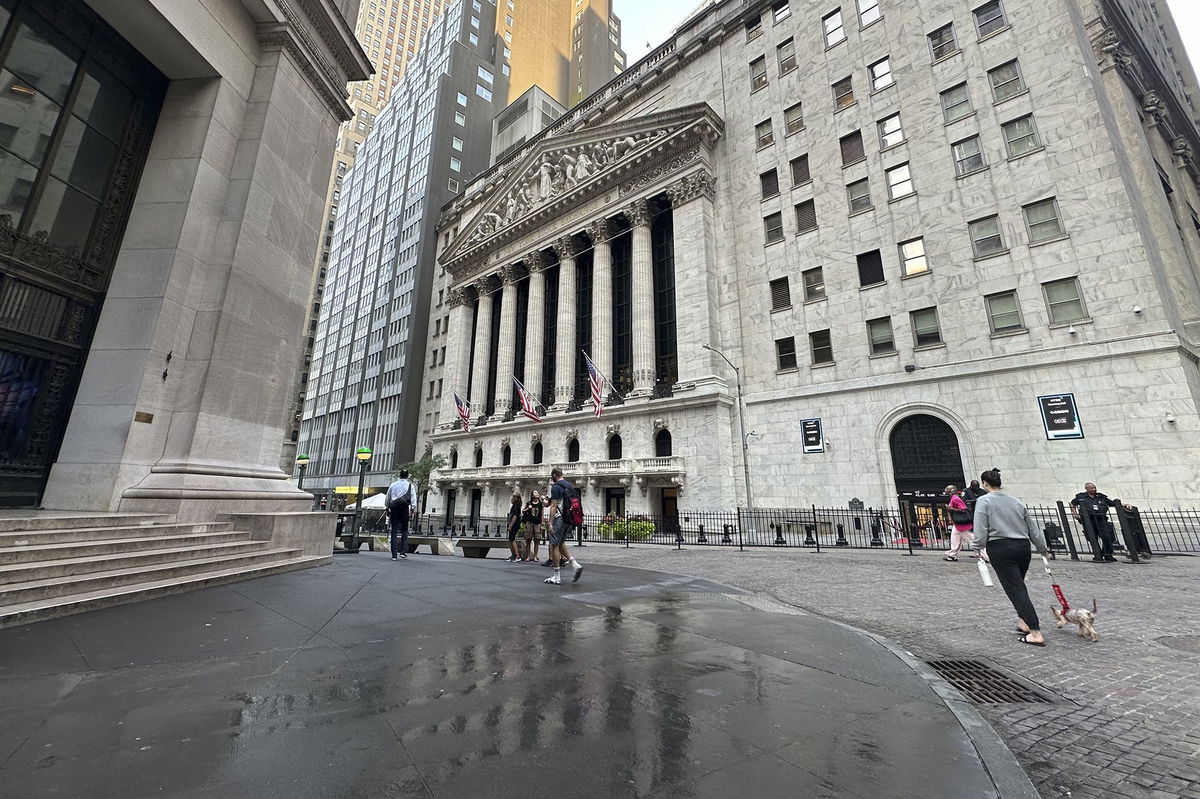 <i>Peter Morgan/AP via CNN Newsource</i><br/>People pass the New York Stock Exchange on August 28.